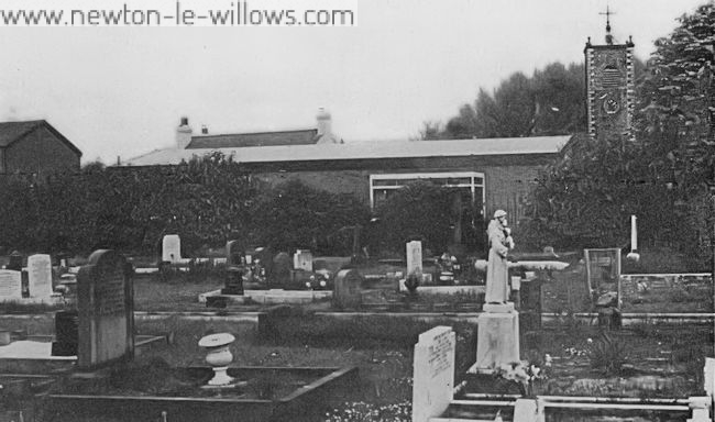 St. Michael’s Church 1975.  Old and new—the graveyard, the village library and the tower of St Michaels in the background.